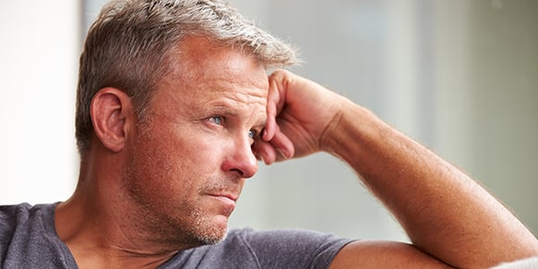 Man leaning on his hand looking out